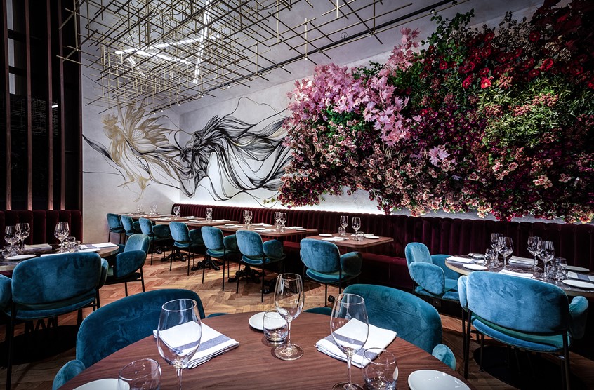 illustration of Rooster has been a mascot of La Gare restaurant for many years. The illustration conveys the message of smoke and aroma going through the restaurant, covering the walls and ending with a shape of a rooster. Like if it were a guardian, that flew throughout whole restaurant, ensuring the quality and French cooking tradition.