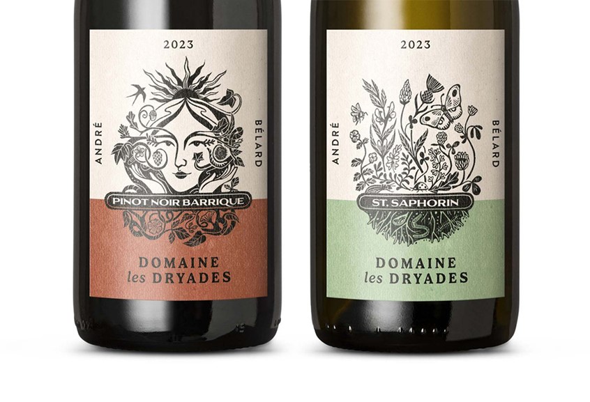 illustration of Two black and white linocut illustrations for the 2023 wine bottle labels from Domaine Les Dryades, an organic vineyard and winery in Lavaux, specialising in agro-ecology. The red label features the name-sake dryad surrounded by natural landscape features, while the white label depicts some smaller details - pollinators and other beneficial insects, companion plants and other natural elements, including worms and roots within the soil.