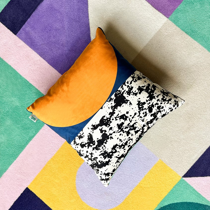 illustration of This decorative cushion features a different design on both sides. It is filled with 100 % natural down, providing softness and warmth. Cover material: durable and soft polyamide. 45 x 45 cm.